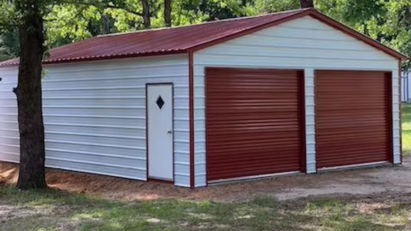 Steel shop building in Tyler, Texas featuring large roll-up doors and durable construction for commercial or personal use.